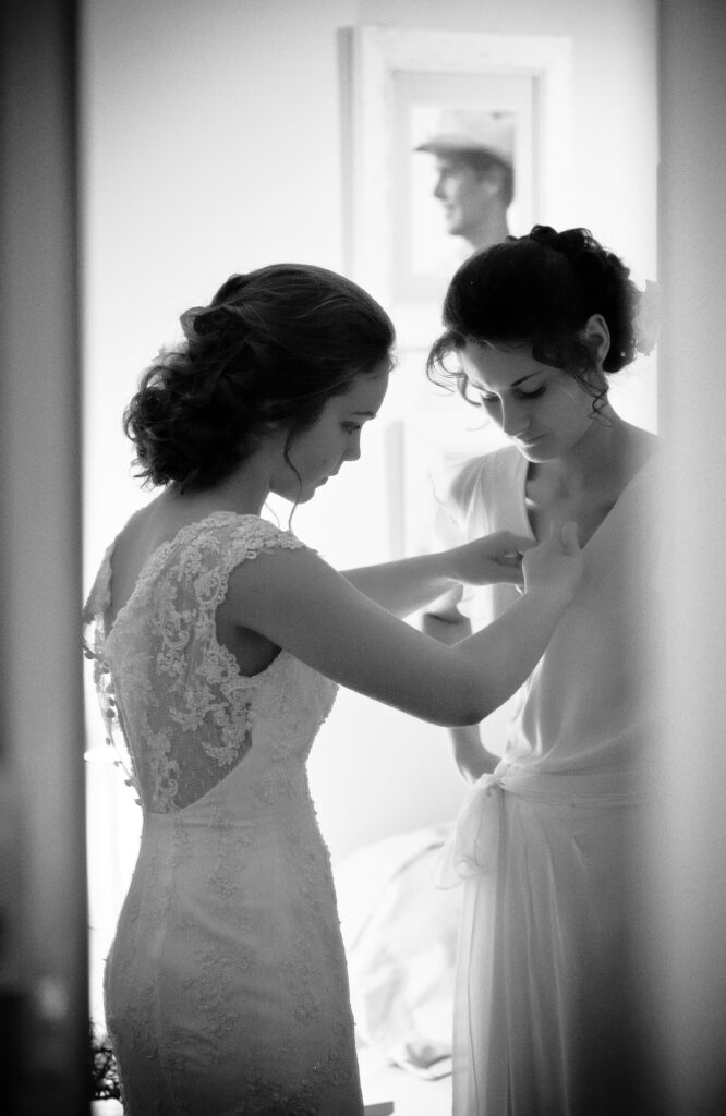 bridesmaids helping each other to dress