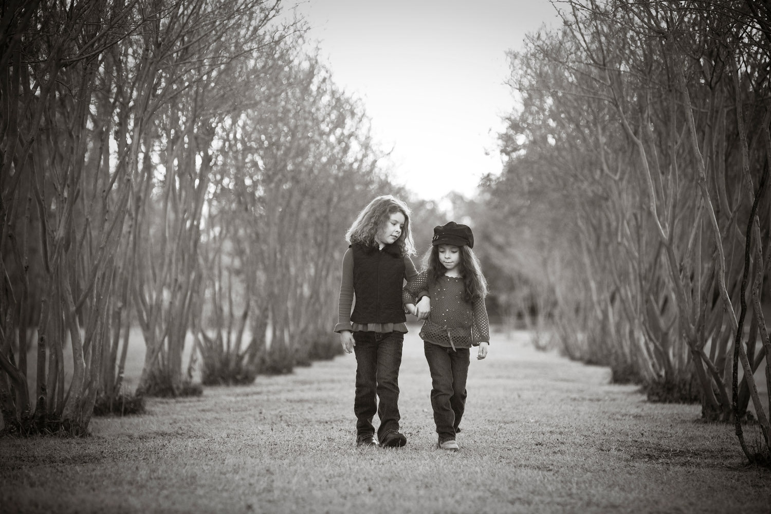 two sisters holding hands walking together