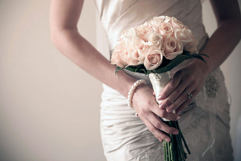 wedding flower and jewellery details on the bride