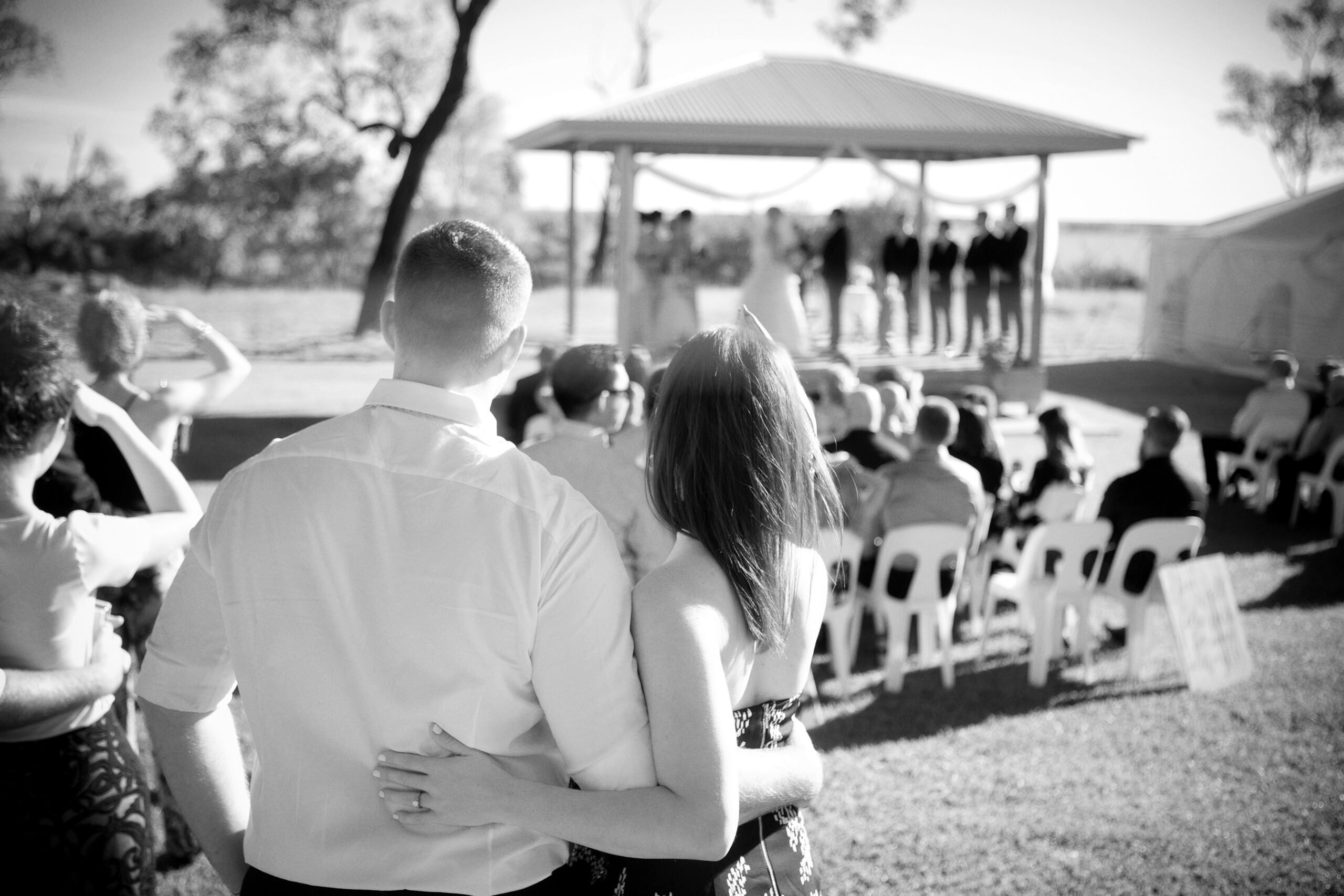 couple looking on at wedding ceremony