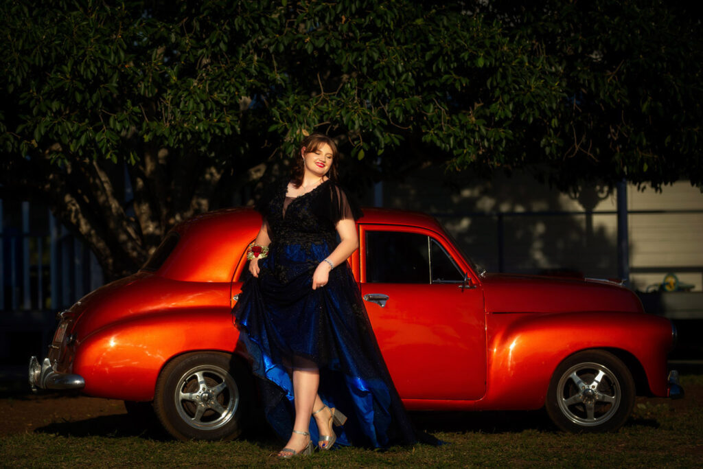 year 12 formal image of girl next to car