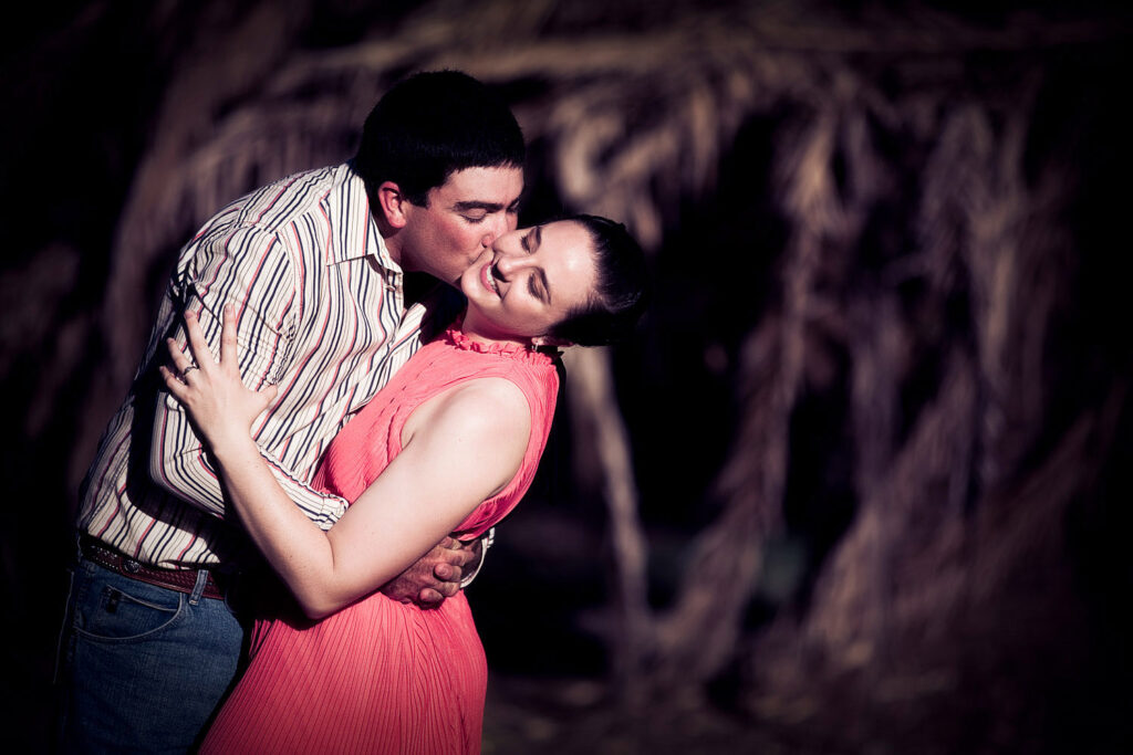 engaged couple kissing