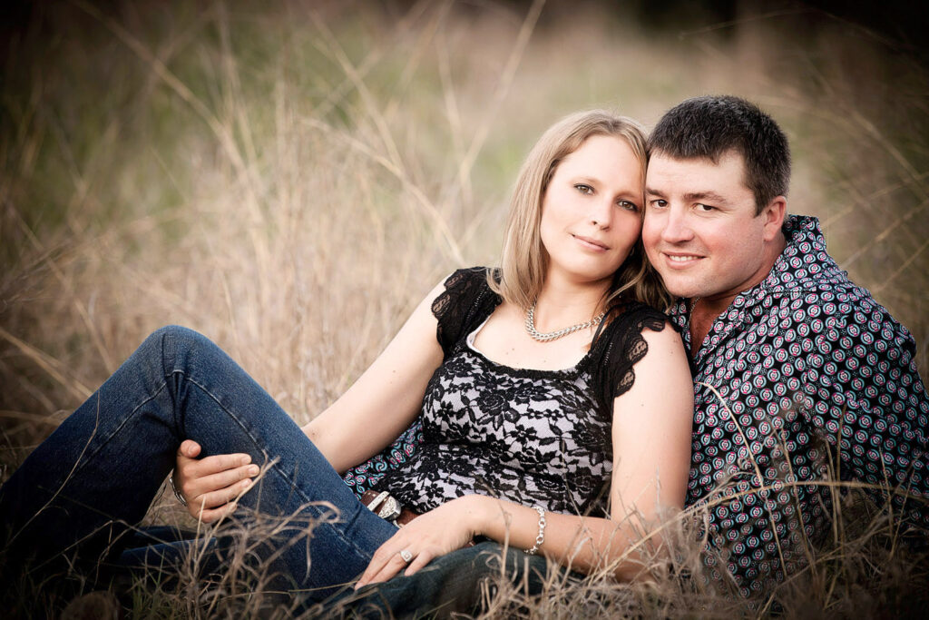 engaged couple in grass