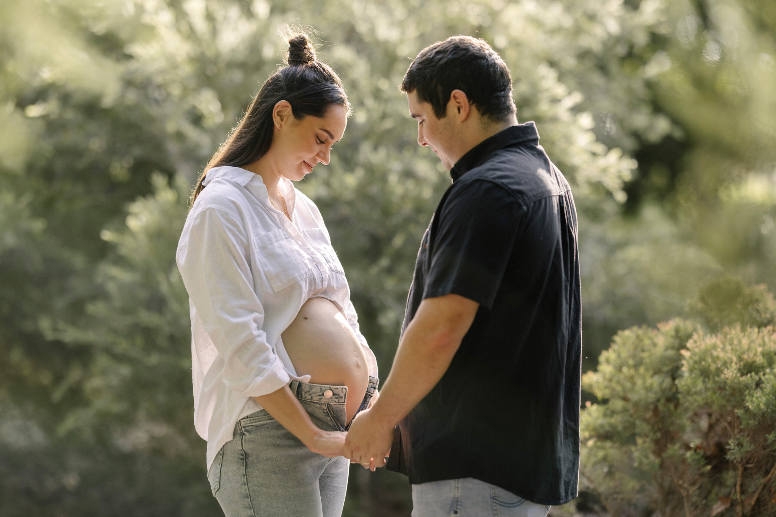 Couple expecting their first child looking at the maternity belly