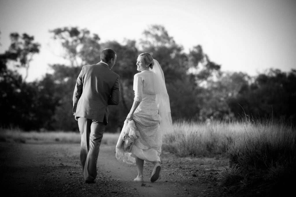 wedding couple walking down rural road