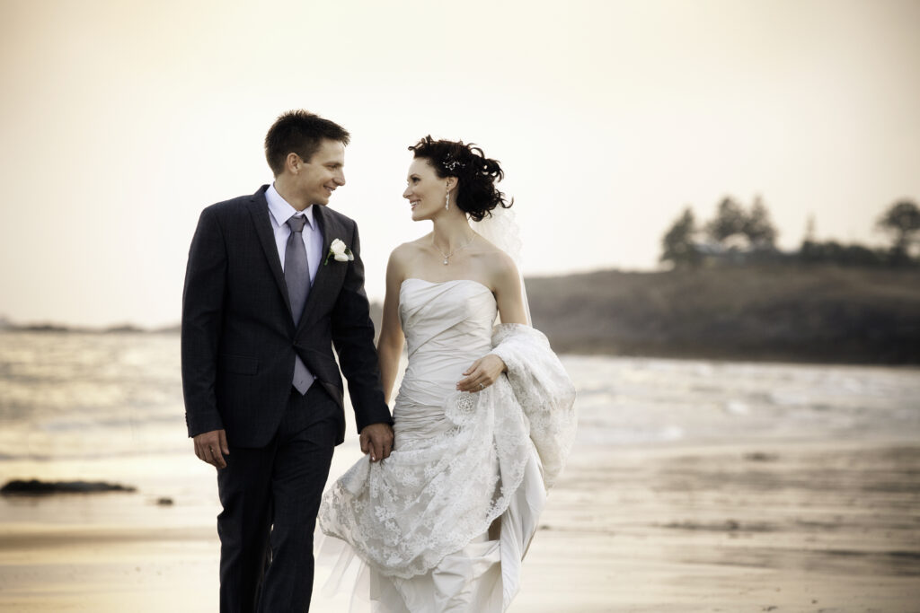 wedding couple walking along beach