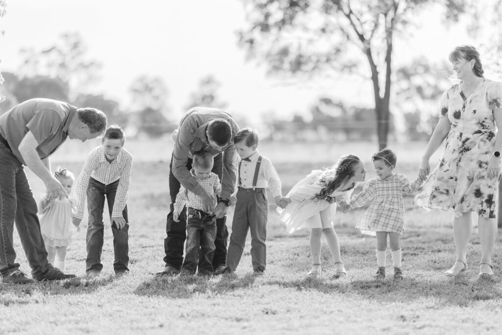 family photograph of parents trying to get kids sorted before formal photo is taken