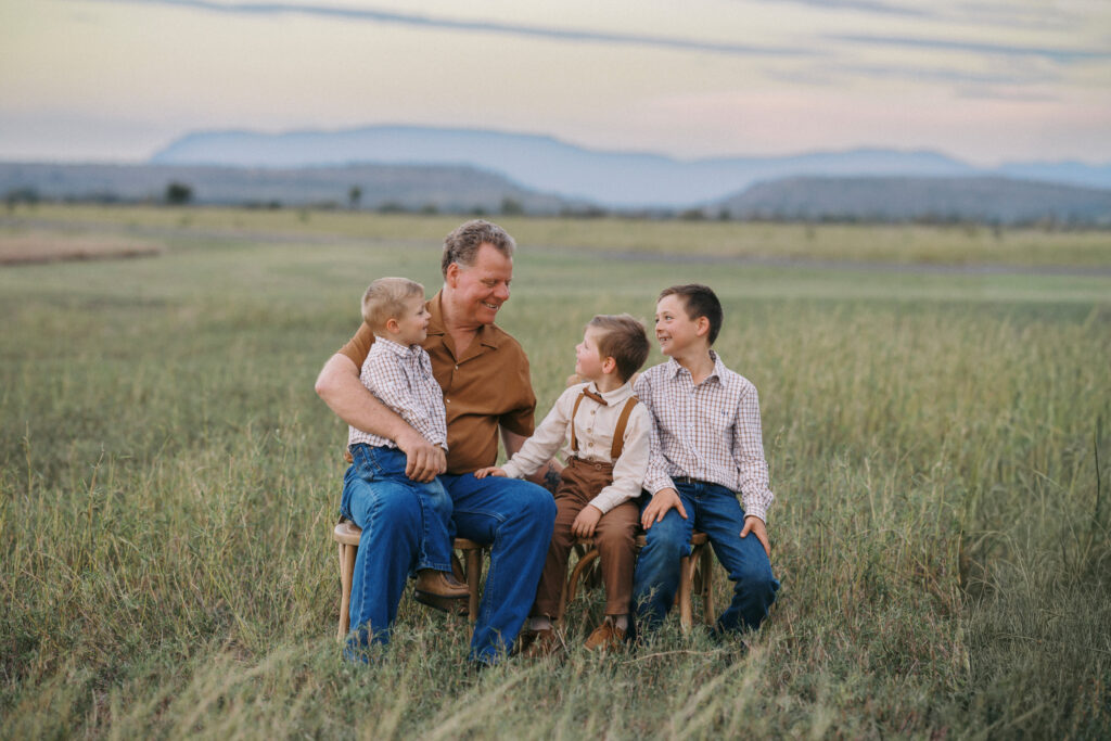 grandfather with his grandsons in field