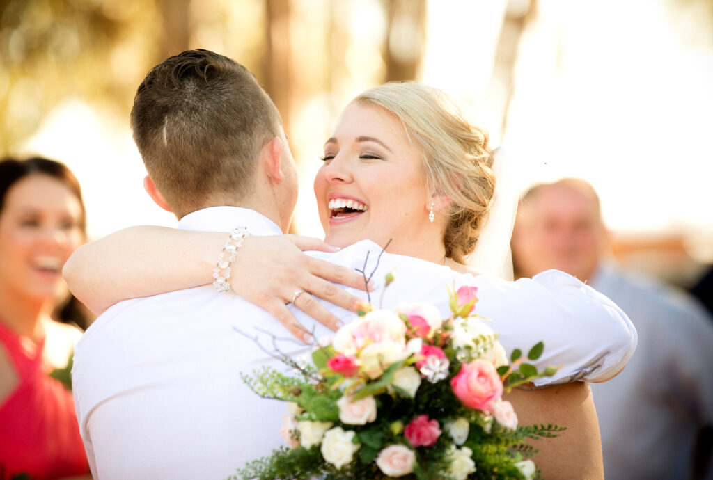 bride hugging guest and having a relaxed, fun time
