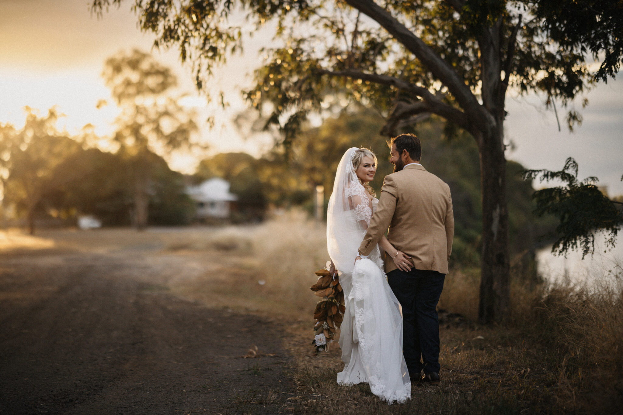 bride and groom walking along river bank Rockhampton