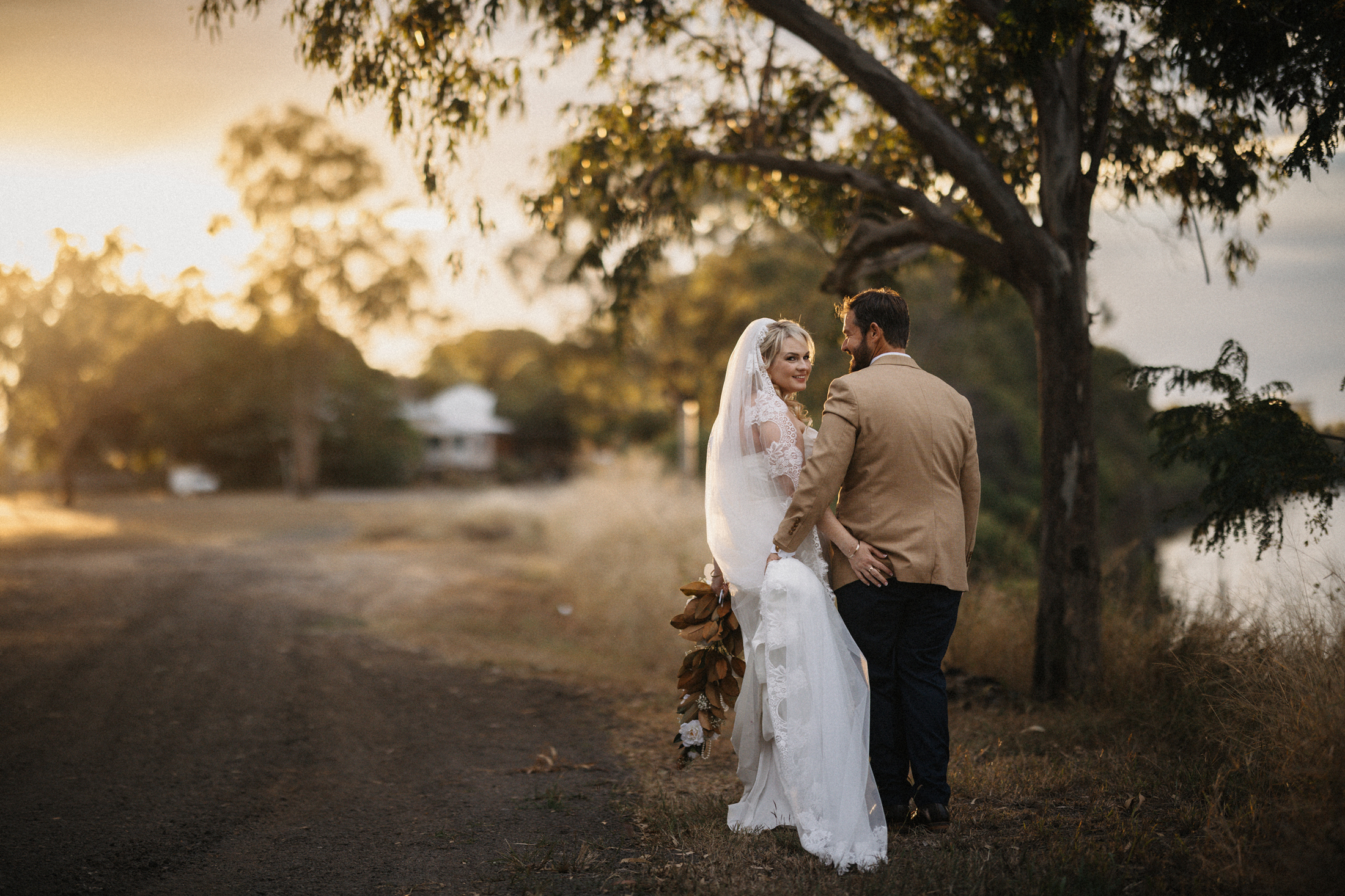 bride and groom walking along river bank Rockhampton